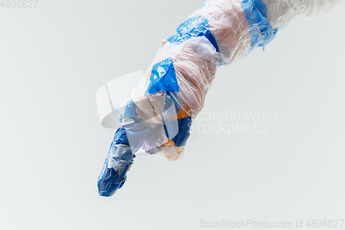 Image of Big plastic hand made of garbage isolated on white studio background