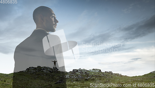 Image of Silhouette of businessman with landscapes on background, double exposure.