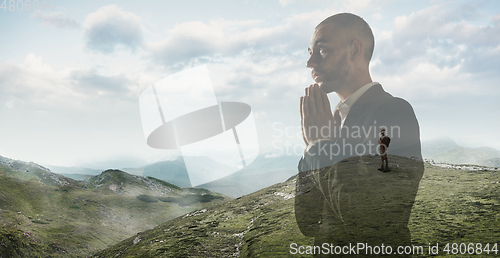 Image of Silhouette of businessman with landscapes on background, double exposure.