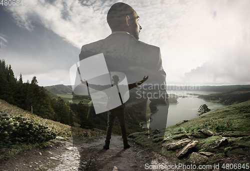 Image of Silhouette of businessman with landscapes on background, double exposure.