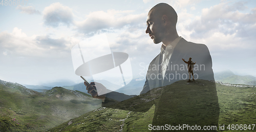 Image of Silhouette of businessman with landscapes on background, double exposure.