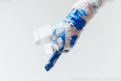 Image of Big plastic hand made of garbage isolated on white studio background