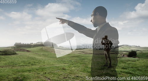 Image of Silhouette of businessman with landscapes on background, double exposure.