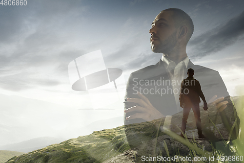 Image of Silhouette of businessman with landscapes on background, double exposure.