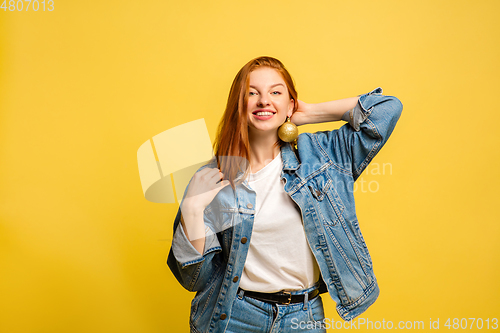 Image of Caucasian woman\'s portrait isolated on yellow studio background