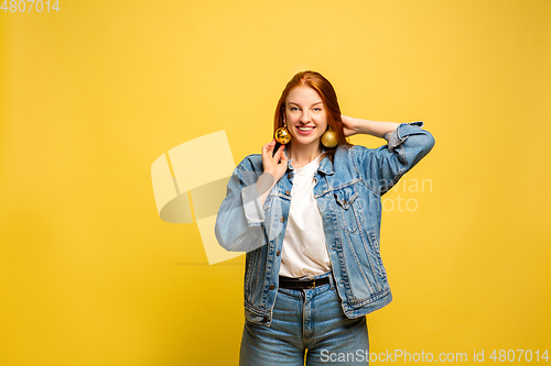 Image of Caucasian woman\'s portrait isolated on yellow studio background