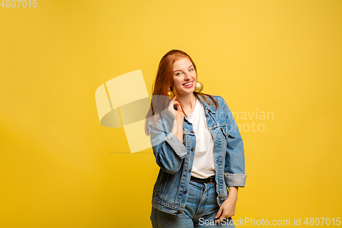 Image of Caucasian woman\'s portrait isolated on yellow studio background