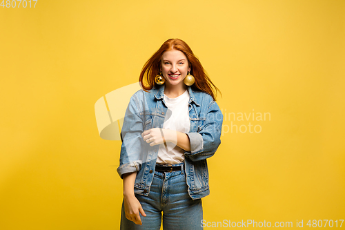 Image of Caucasian woman\'s portrait isolated on yellow studio background