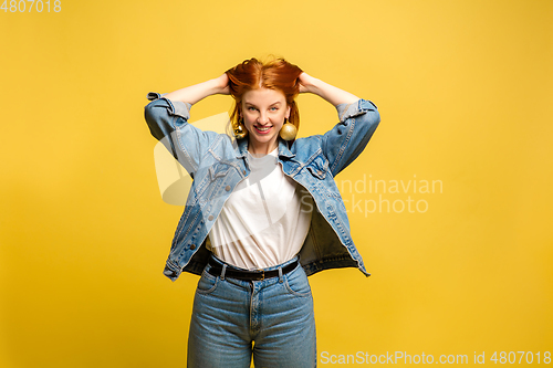 Image of Caucasian woman\'s portrait isolated on yellow studio background