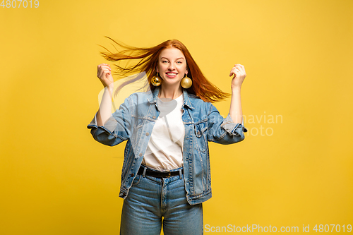 Image of Caucasian woman\'s portrait isolated on yellow studio background