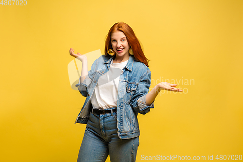 Image of Caucasian woman\'s portrait isolated on yellow studio background