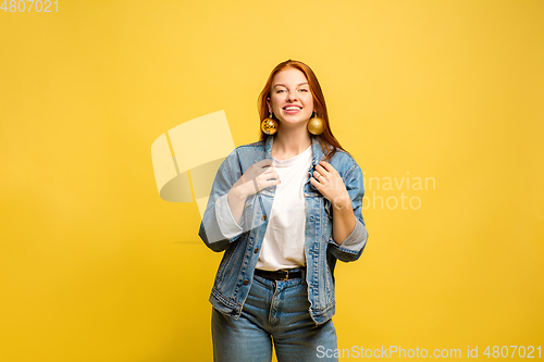 Image of Caucasian woman\'s portrait isolated on yellow studio background