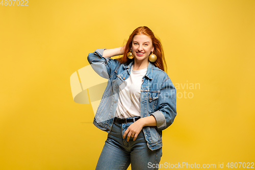 Image of Caucasian woman\'s portrait isolated on yellow studio background