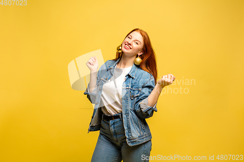Image of Caucasian woman\'s portrait isolated on yellow studio background