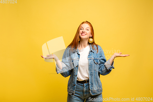 Image of Caucasian woman\'s portrait isolated on yellow studio background