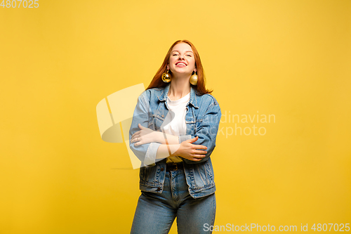 Image of Caucasian woman\'s portrait isolated on yellow studio background