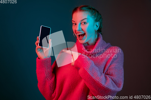 Image of Caucasian woman\'s portrait isolated on gradient studio background in neon light