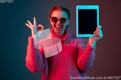 Image of Caucasian woman\'s portrait isolated on gradient studio background in neon light