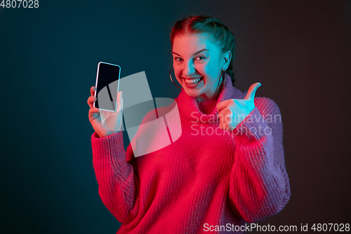 Image of Caucasian woman\'s portrait isolated on gradient studio background in neon light