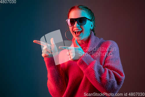 Image of Caucasian woman\'s portrait isolated on gradient studio background in neon light