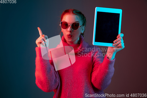 Image of Caucasian woman\'s portrait isolated on gradient studio background in neon light