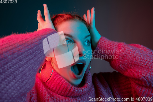 Image of Caucasian woman\'s portrait isolated on gradient studio background in neon light