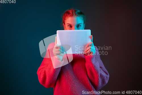 Image of Caucasian woman\'s portrait isolated on gradient studio background in neon light