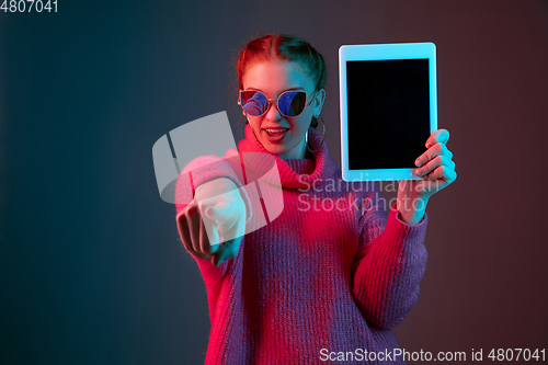 Image of Caucasian woman\'s portrait isolated on gradient studio background in neon light