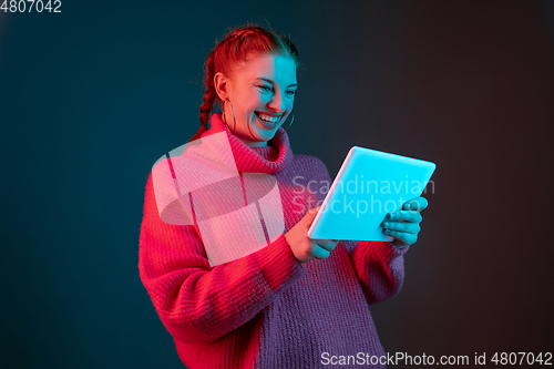 Image of Caucasian woman\'s portrait isolated on gradient studio background in neon light