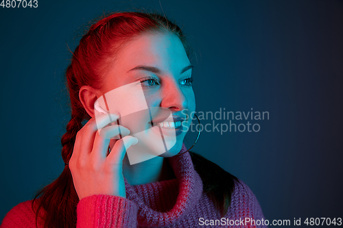 Image of Caucasian woman\'s portrait isolated on gradient studio background in neon light