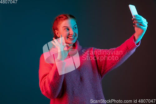 Image of Caucasian woman\'s portrait isolated on gradient studio background in neon light