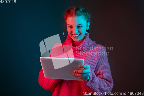 Image of Caucasian woman\'s portrait isolated on gradient studio background in neon light