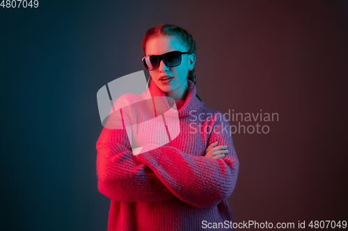 Image of Caucasian woman\'s portrait isolated on gradient studio background in neon light