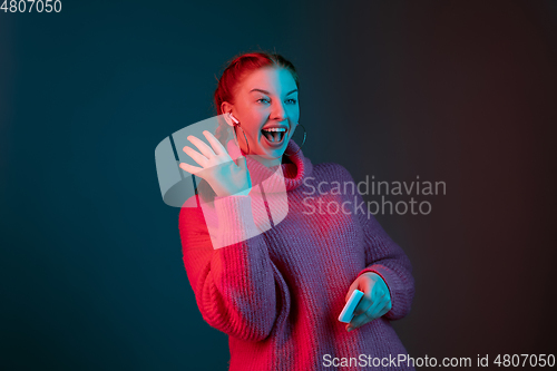 Image of Caucasian woman\'s portrait isolated on gradient studio background in neon light
