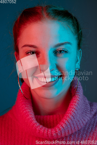 Image of Caucasian woman\'s portrait isolated on gradient studio background in neon light