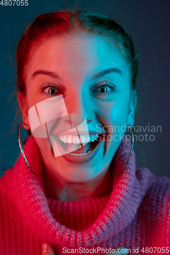 Image of Caucasian woman\'s portrait isolated on gradient studio background in neon light