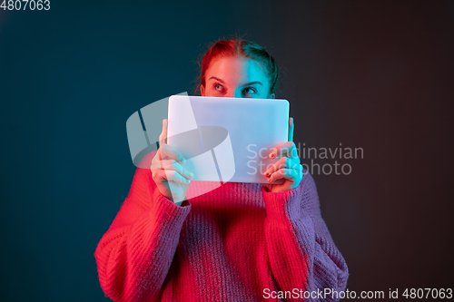 Image of Caucasian woman\'s portrait isolated on gradient studio background in neon light