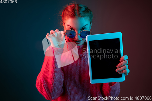 Image of Caucasian woman\'s portrait isolated on gradient studio background in neon light