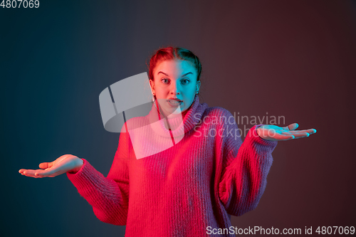 Image of Caucasian woman\'s portrait isolated on gradient studio background in neon light