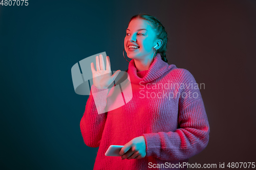 Image of Caucasian woman\'s portrait isolated on gradient studio background in neon light