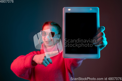 Image of Caucasian woman\'s portrait isolated on gradient studio background in neon light