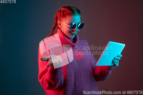 Image of Caucasian woman\'s portrait isolated on gradient studio background in neon light