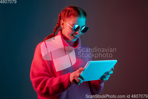 Image of Caucasian woman\'s portrait isolated on gradient studio background in neon light