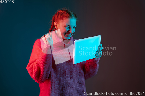 Image of Caucasian woman\'s portrait isolated on gradient studio background in neon light