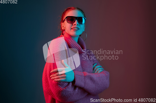 Image of Caucasian woman\'s portrait isolated on gradient studio background in neon light