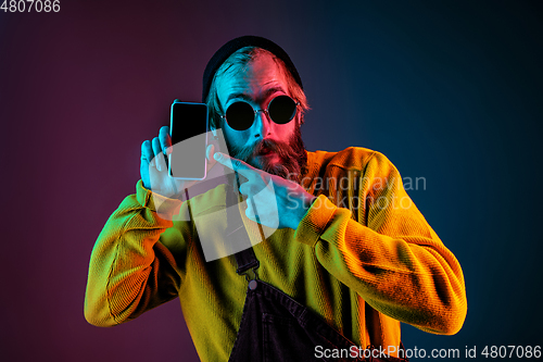 Image of Caucasian man\'s portrait isolated on gradient studio background in neon light