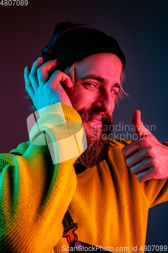 Image of Caucasian man\'s portrait isolated on gradient studio background in neon light