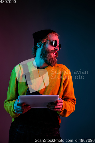 Image of Caucasian man\'s portrait isolated on gradient studio background in neon light