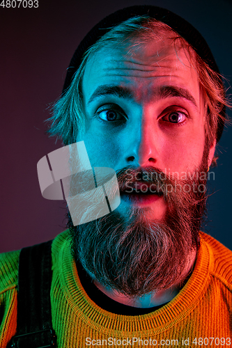 Image of Caucasian man\'s portrait isolated on gradient studio background in neon light