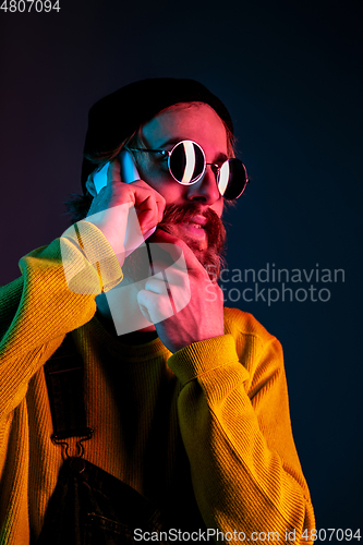 Image of Caucasian man\'s portrait isolated on gradient studio background in neon light